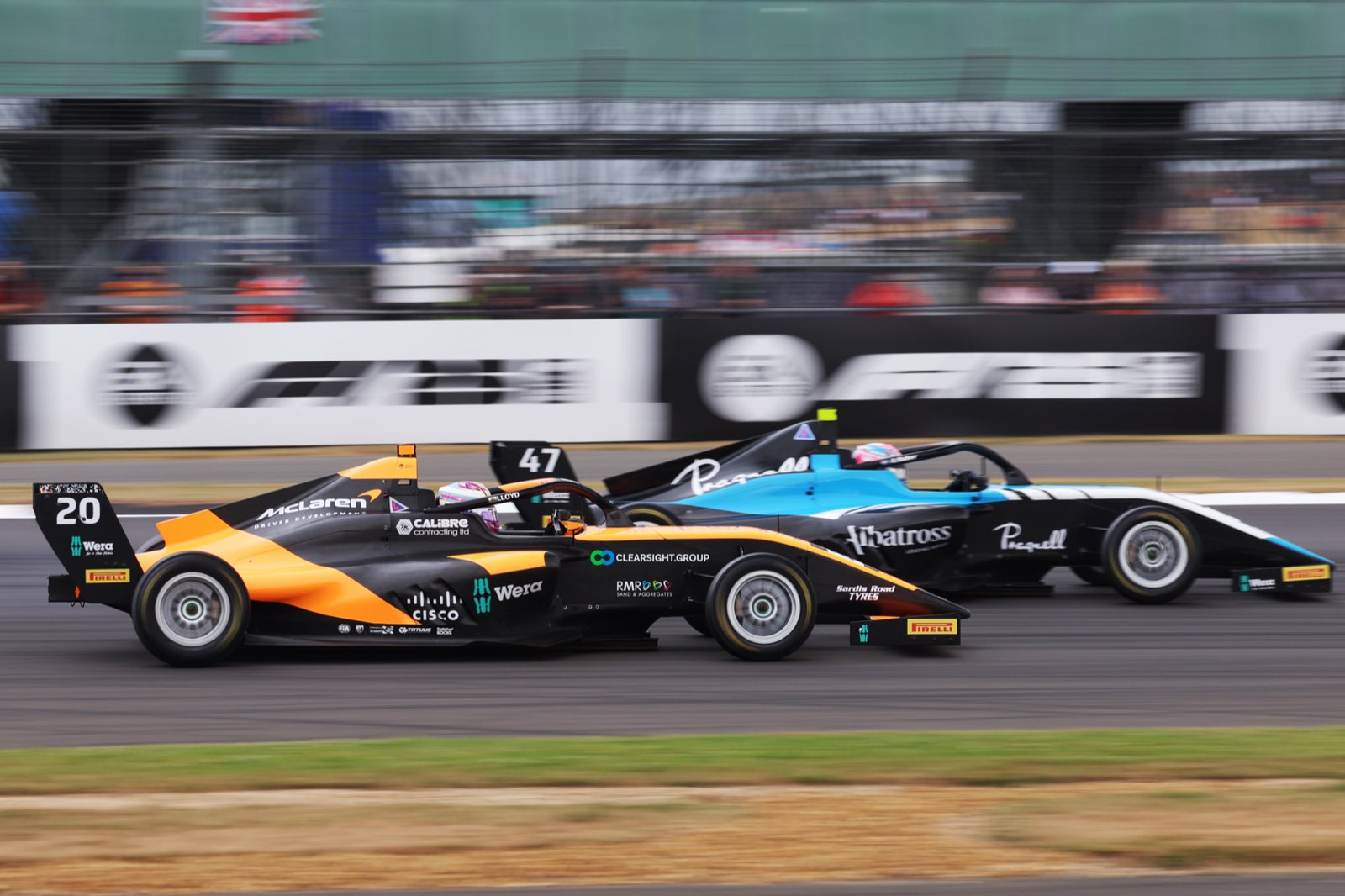 Ella Lloyd racing wheel to wheel in the no. 20 McLaren F1 Academy car carrying Clearsight branding
